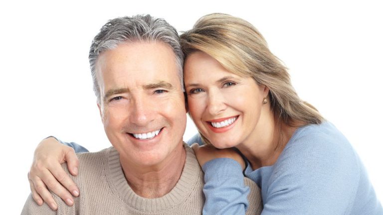 Smiling Couple Post Dental Implant Treatment